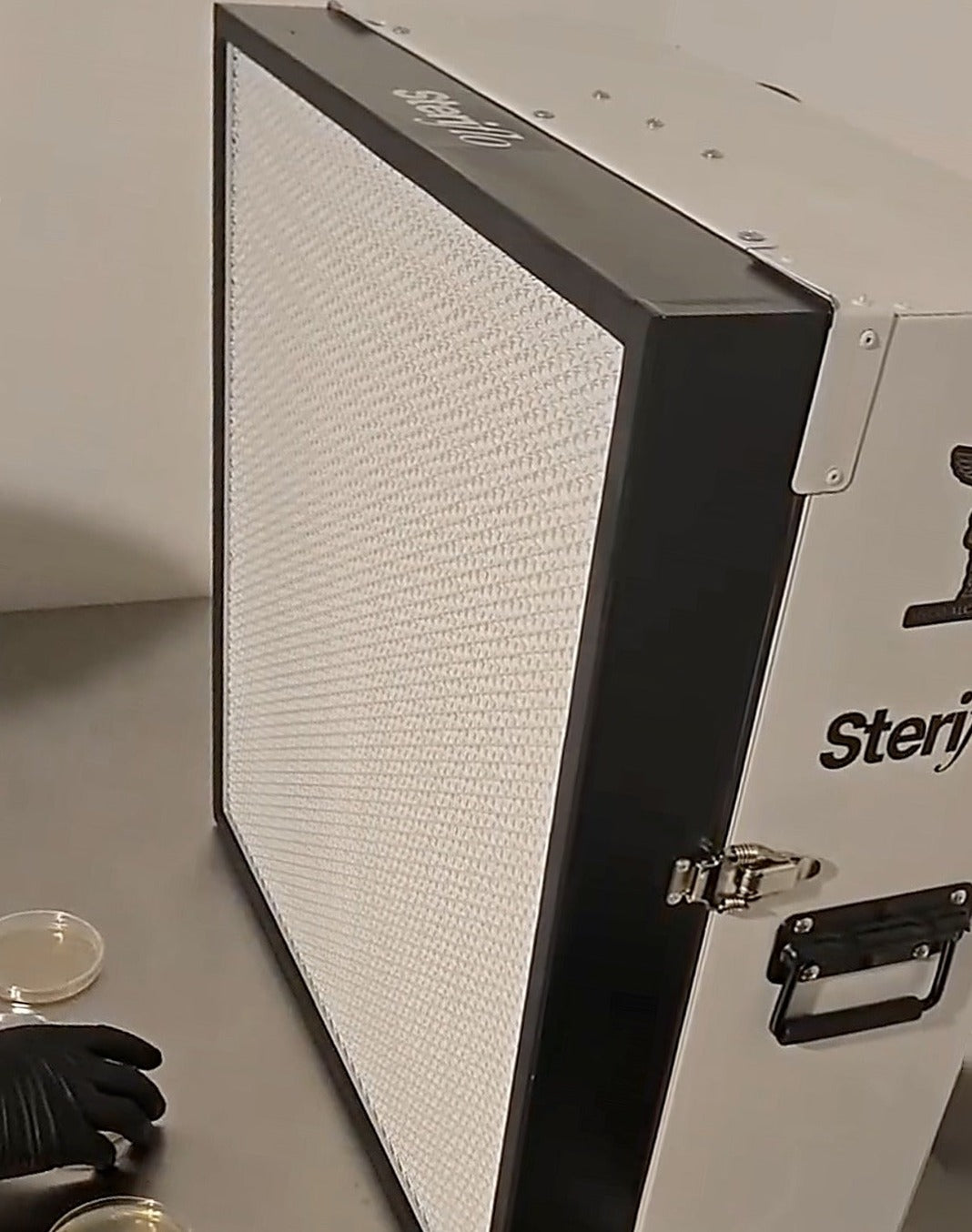 Steriflo HEPA flow hood on a steel bench with agar plates